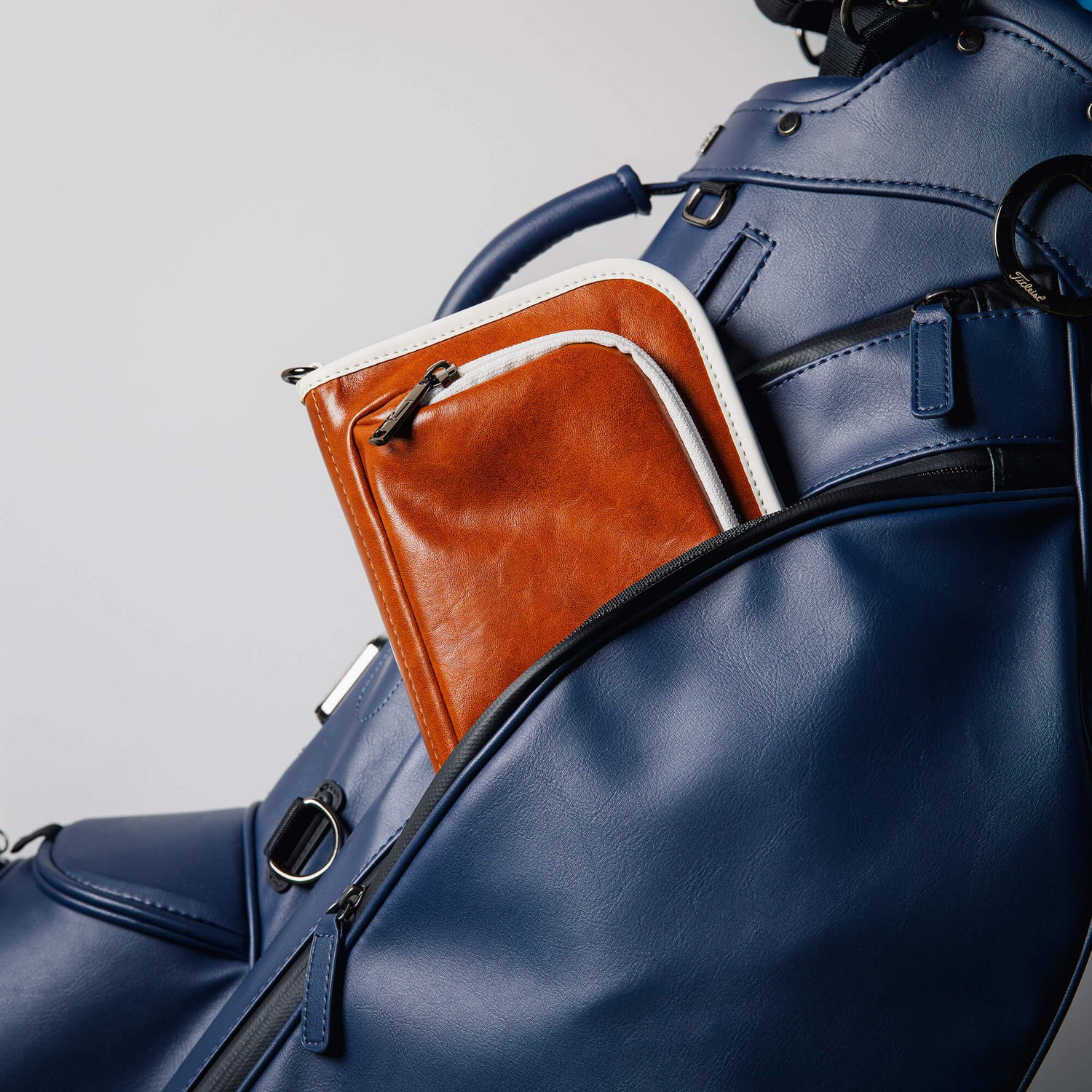 Blue leather golf bag with a brown leather Jolly Golf bag organizer pouch.