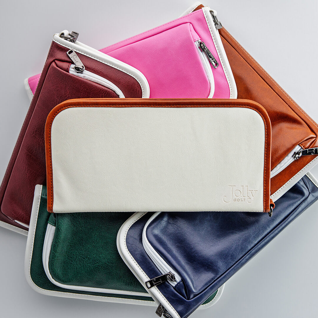 Stack of leather zippered golf bag organizer pouches by Jolly Golf.