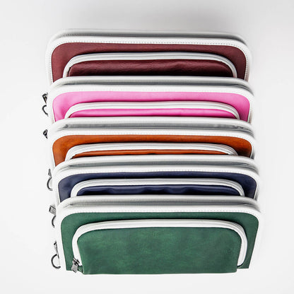 Stack of leather zippered golf bag organizer pouches by Jolly Golf.