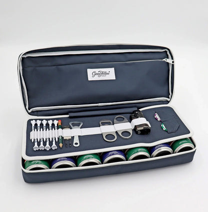 Navy Merrymaker golf organizer shown open with golf tees, pencil, ball markers divot tools, energy drinks and more inside